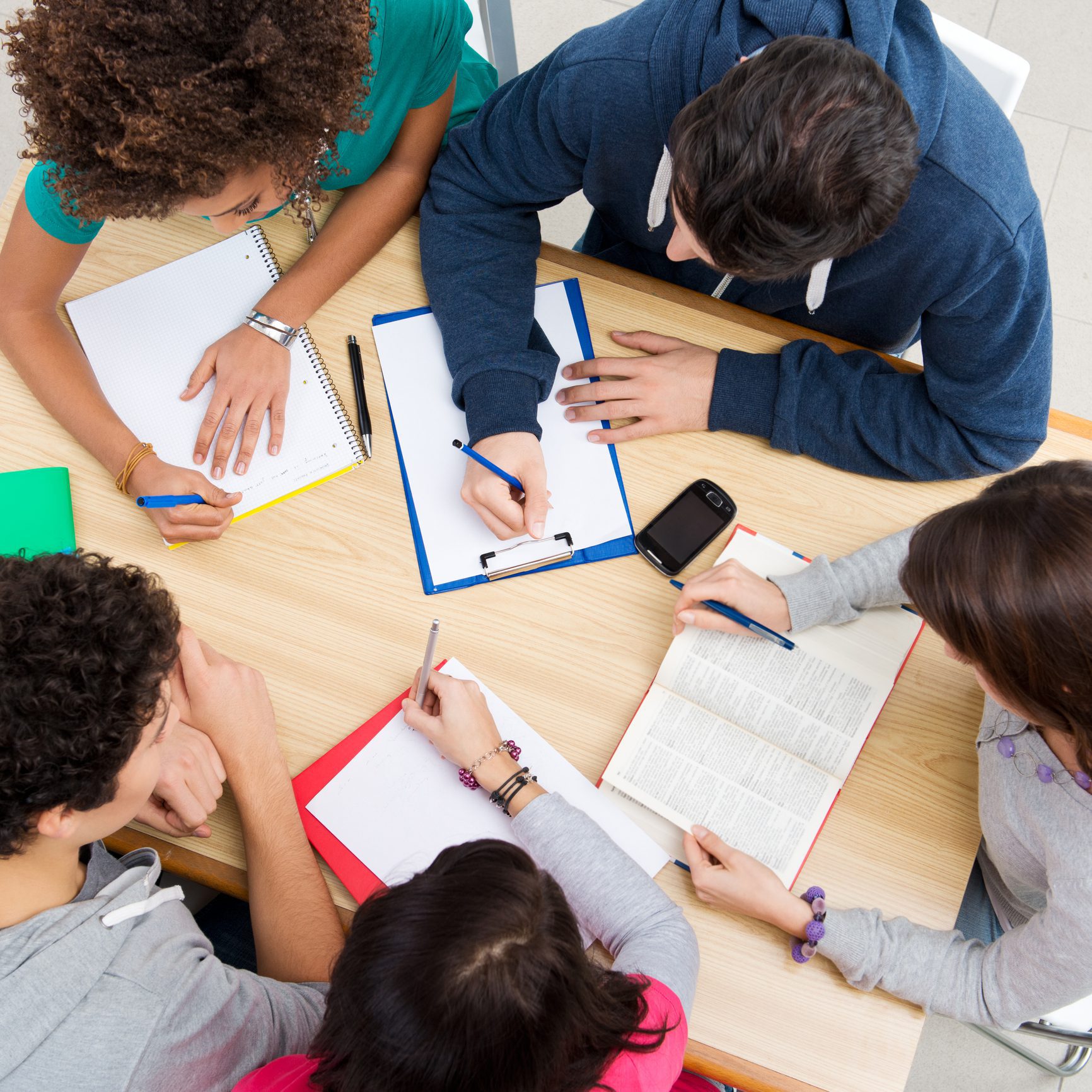 Group of young students studying together at college, high view angle.
